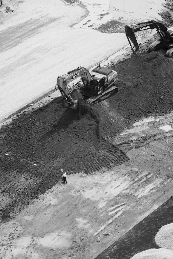 ours-journey Aerial view of construction with excavators and worker in Ciudad de México.